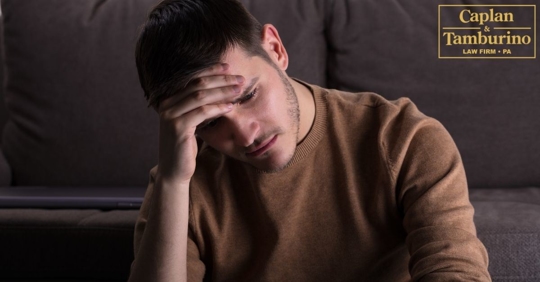 Man looking frustrated while holding his head