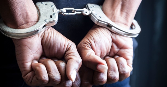 man being placed under arrest